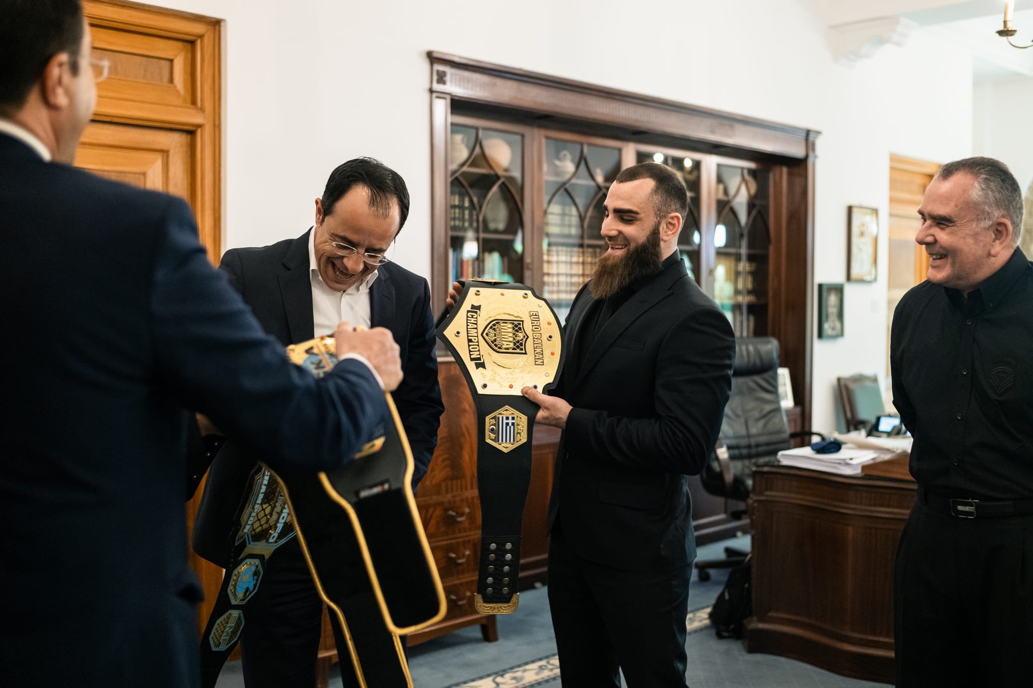 Andreas Tricomitis presenting his EuroBalkan MMA championship belt to President Nikos Christodoulides at the Presidential Palace in Cyprus, 2023